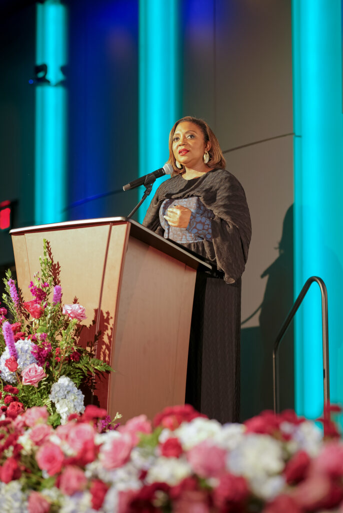 Christal Jackson speaks at the podium during the Lived Story segment of the 35th Anniversary celebration.