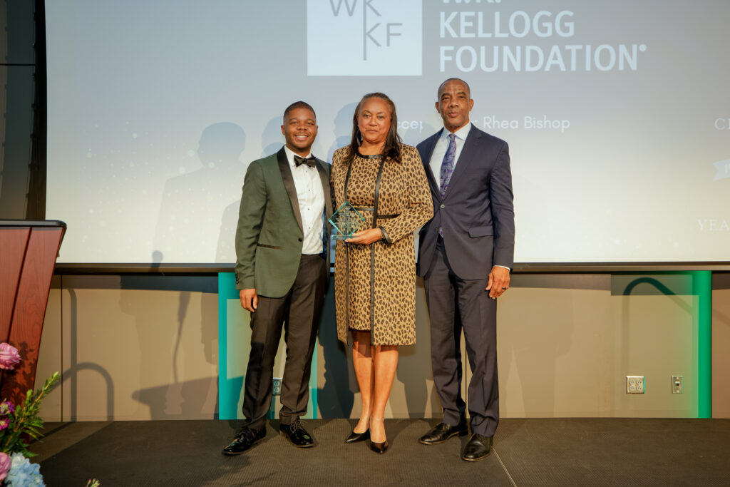 Gregory Johnson, Rhea Bishop from the W.K. Kellogg Foundation, and Chairman of the Board Theo Bunting during the Partnership Award presentation.