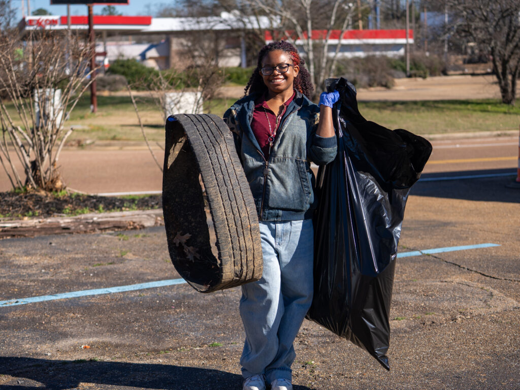 A student participates in a community cleanup project during MLK Day of Service in Jackson.