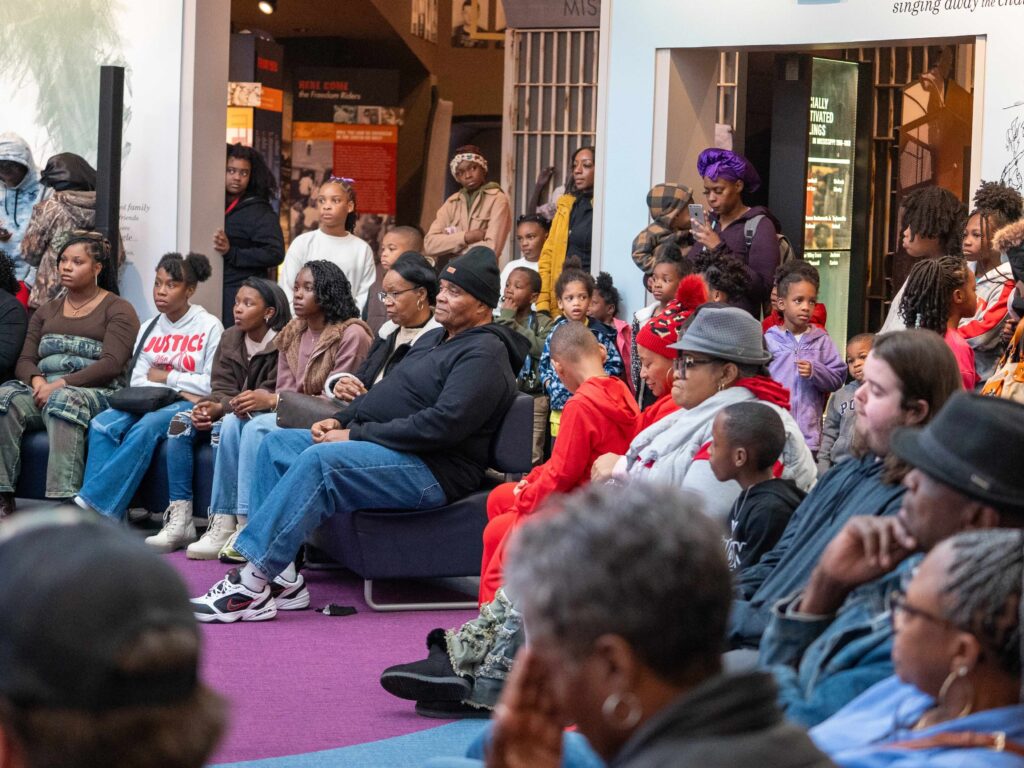 Students and community members sit together inside the Mississippi Civil Rights Museum.